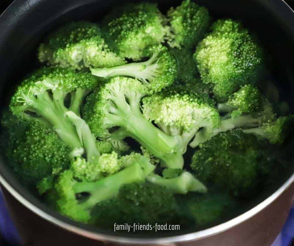 Broccoli florets in a steamer basket.