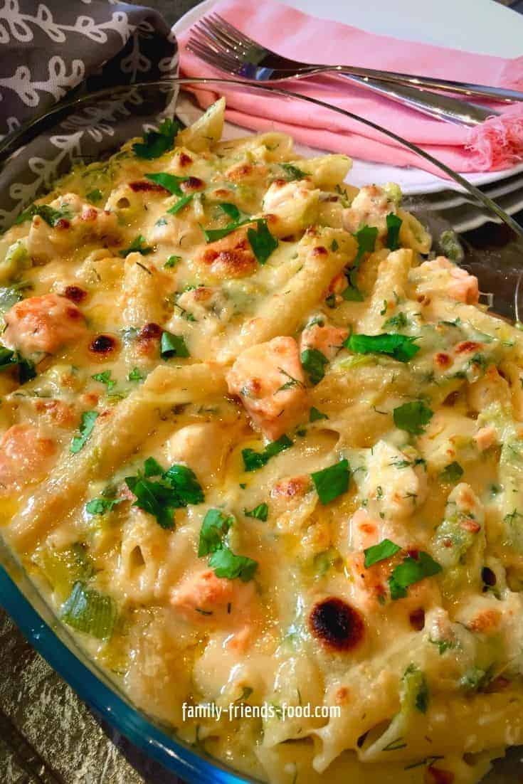 Fish pie pasta bake with plates and cutlery.