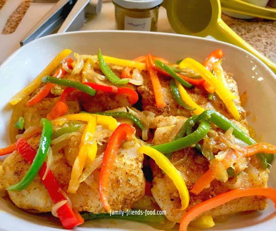 Fish with hawaij and sweet peppers ready to bake.