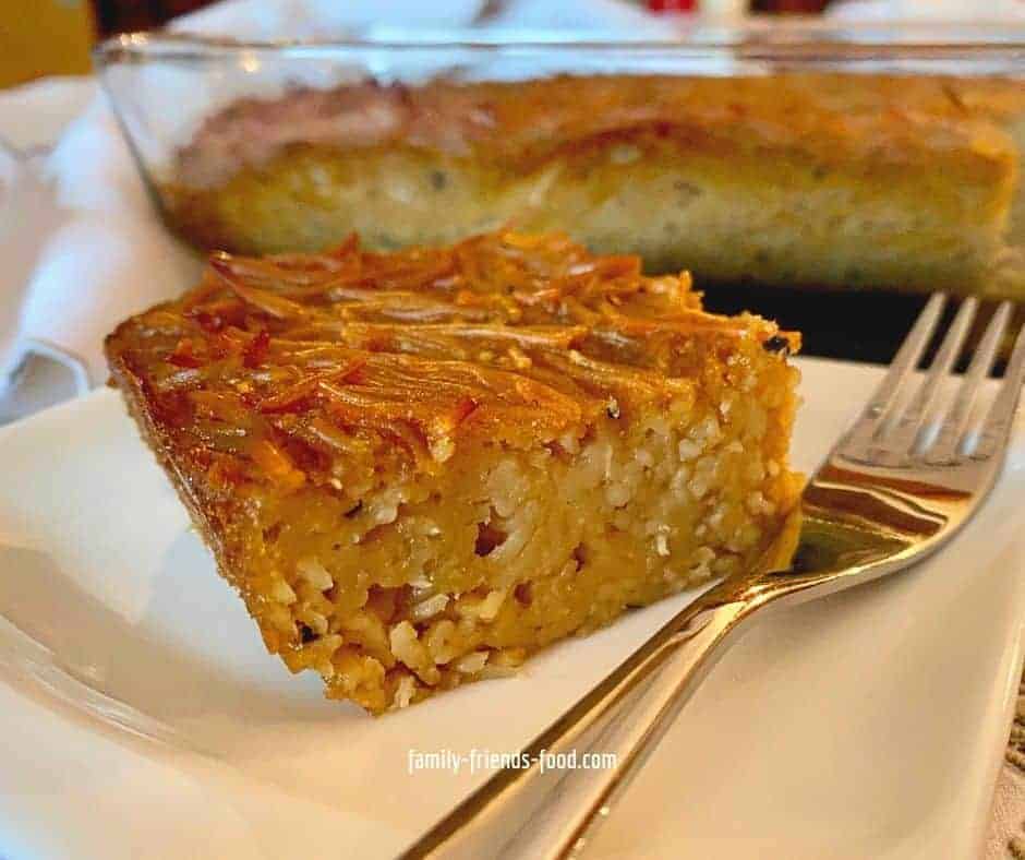 Close up image of a slice of Jerusalem kugel on a plate with a fork.