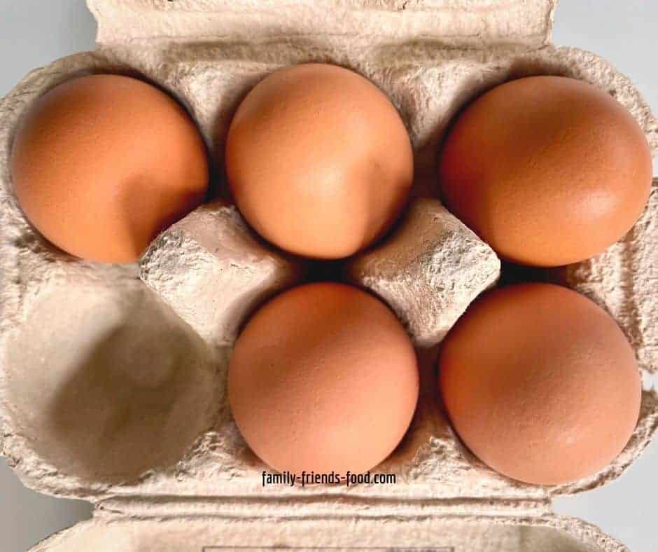 An egg box containing 5 brown eggs.