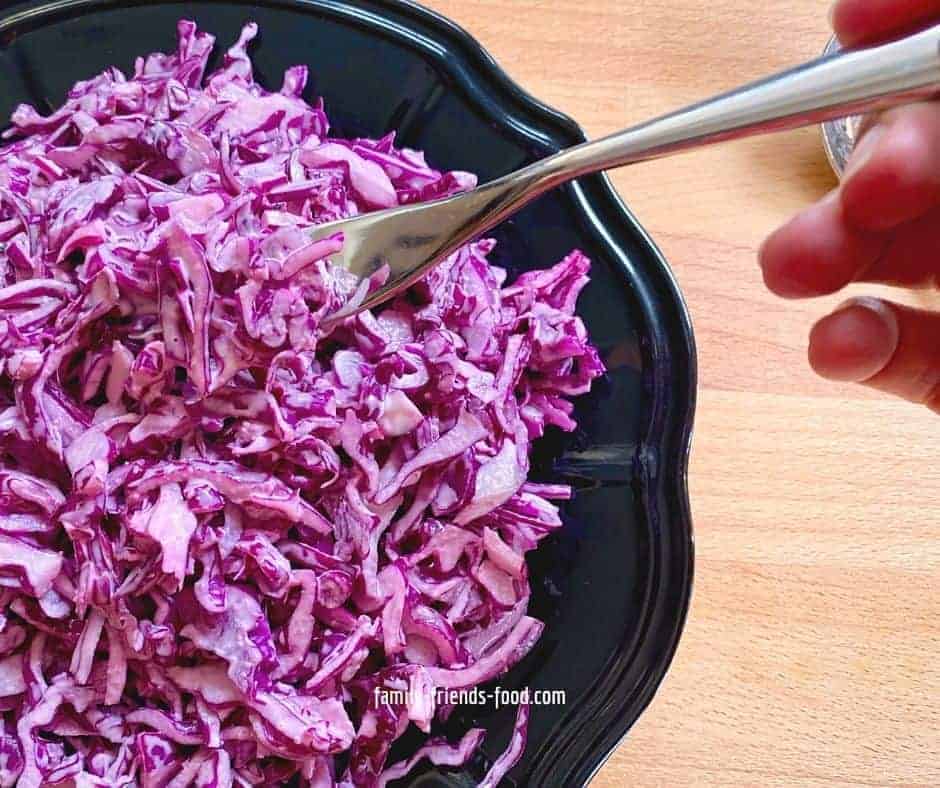 Somebody taking a forkful of red cabbage salad.