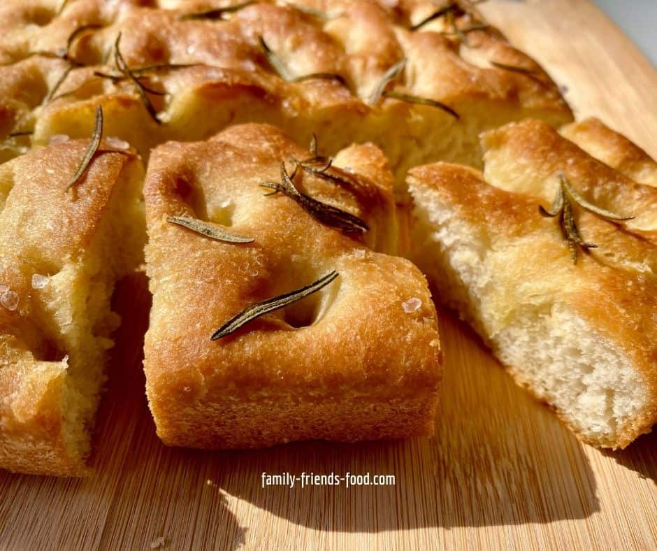 Pieces of focaccia on a wooden board.