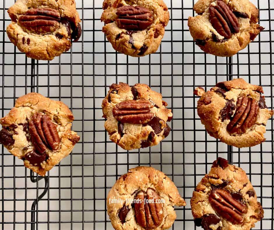 Overhead image of chocolate pecan cookies cooling on a wire rack.